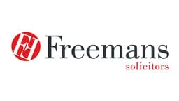 The image shows the logo of Freemans Solicitors. The logo features the firm's name "Freemans" in a professional font, with a distinctive red circular icon, symbolizing strength and trust in the legal services provided.