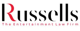 Russells Solicitors logo with stylized red and black lettering and the tagline ‘The Entertainment Law Firm’ beneath