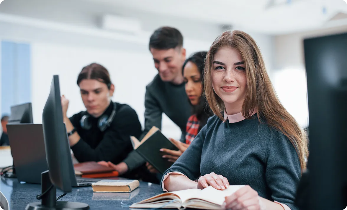 Professionals reviewing books and documents in an office, illustrating collaborative work at a law firm.